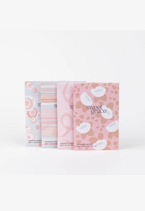 Sweet Grace scented sachets in pink patterned packaging, available at Nora Gray.